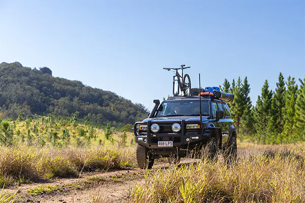 Dmax Roof Racks pictured with bicycle, max traks, water containers, side awning.